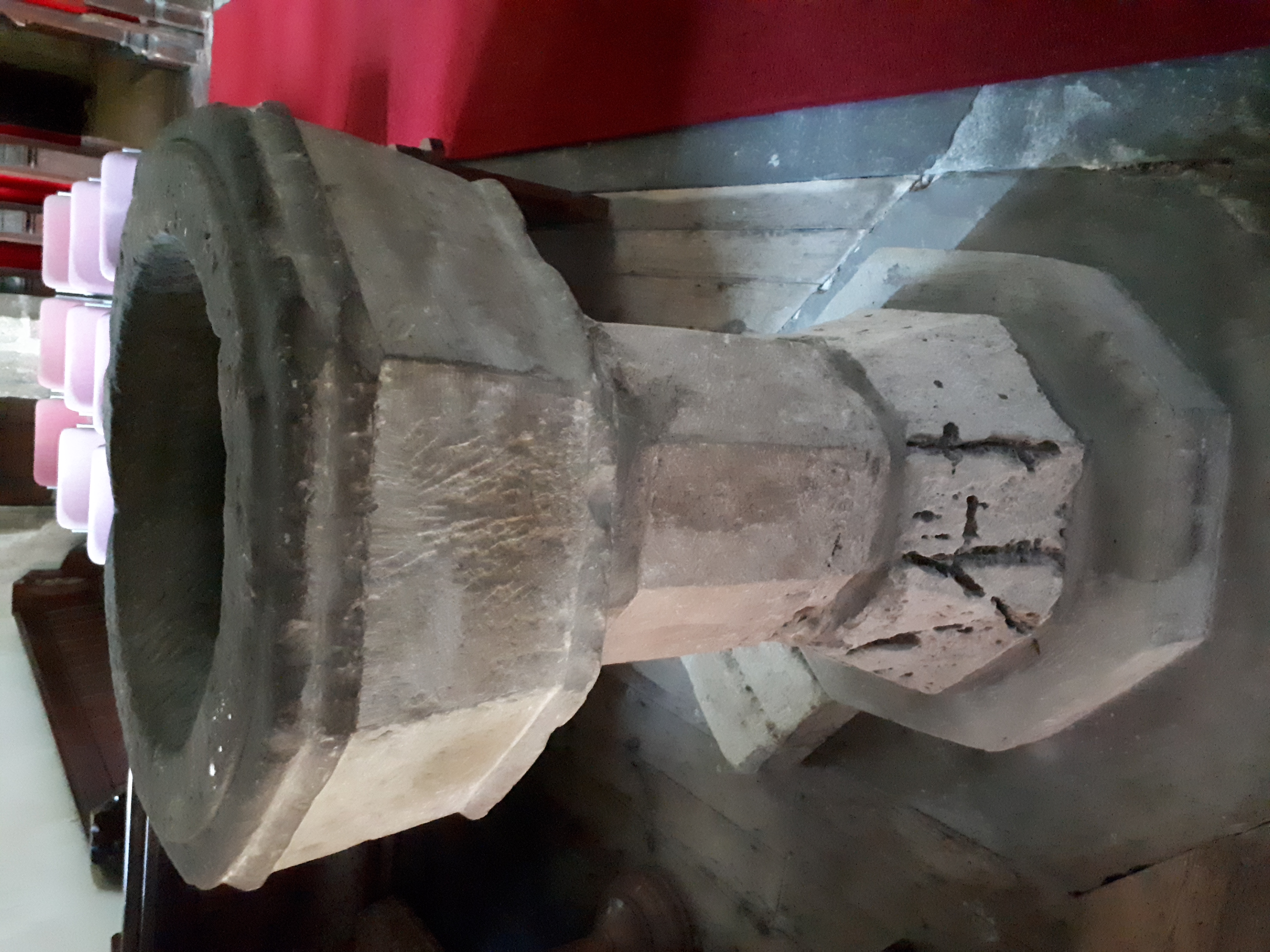 The medieval octagonal stone baptismal font