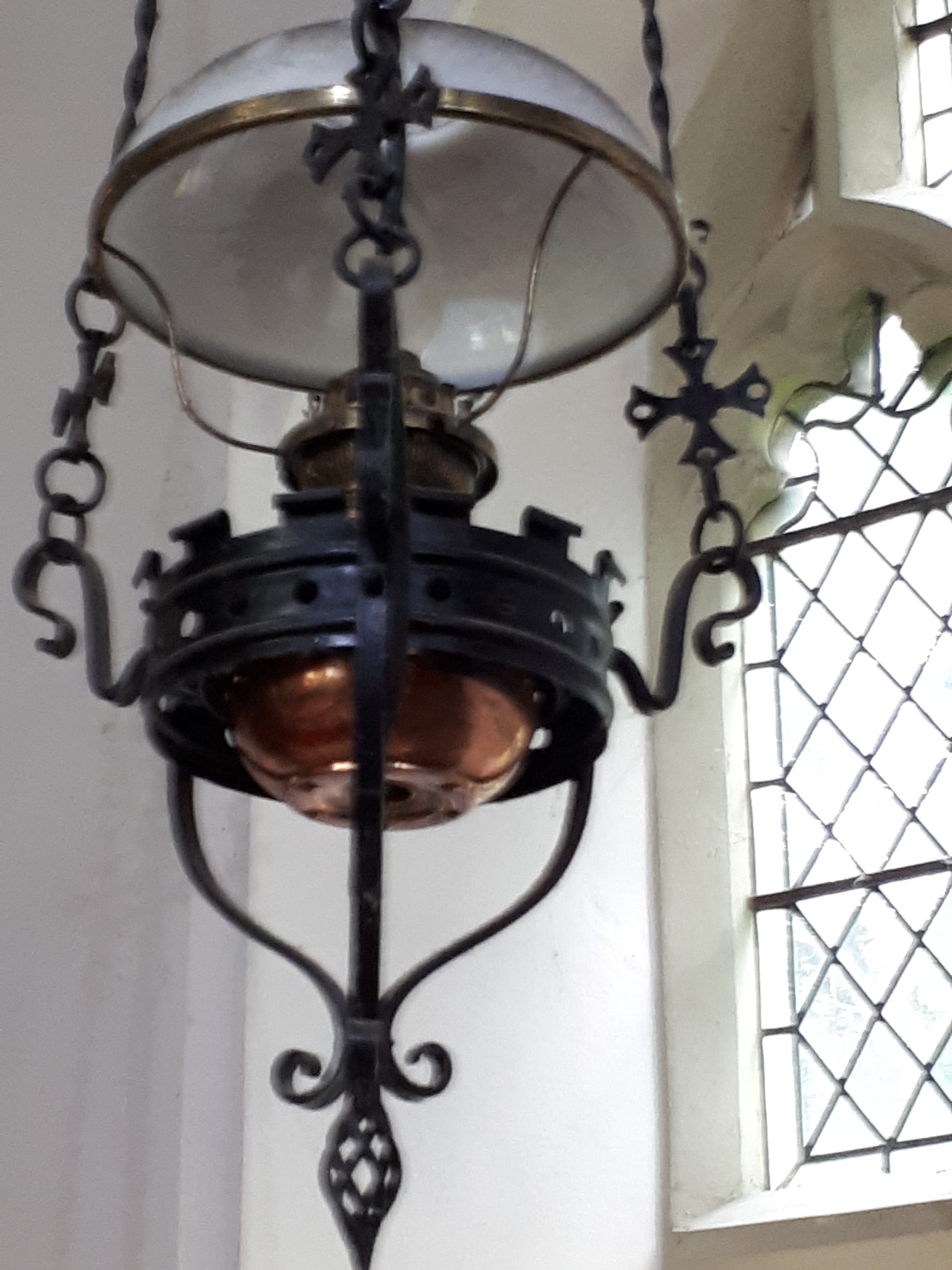 A Victorian oil lamp hanging inside St Nicholas Church