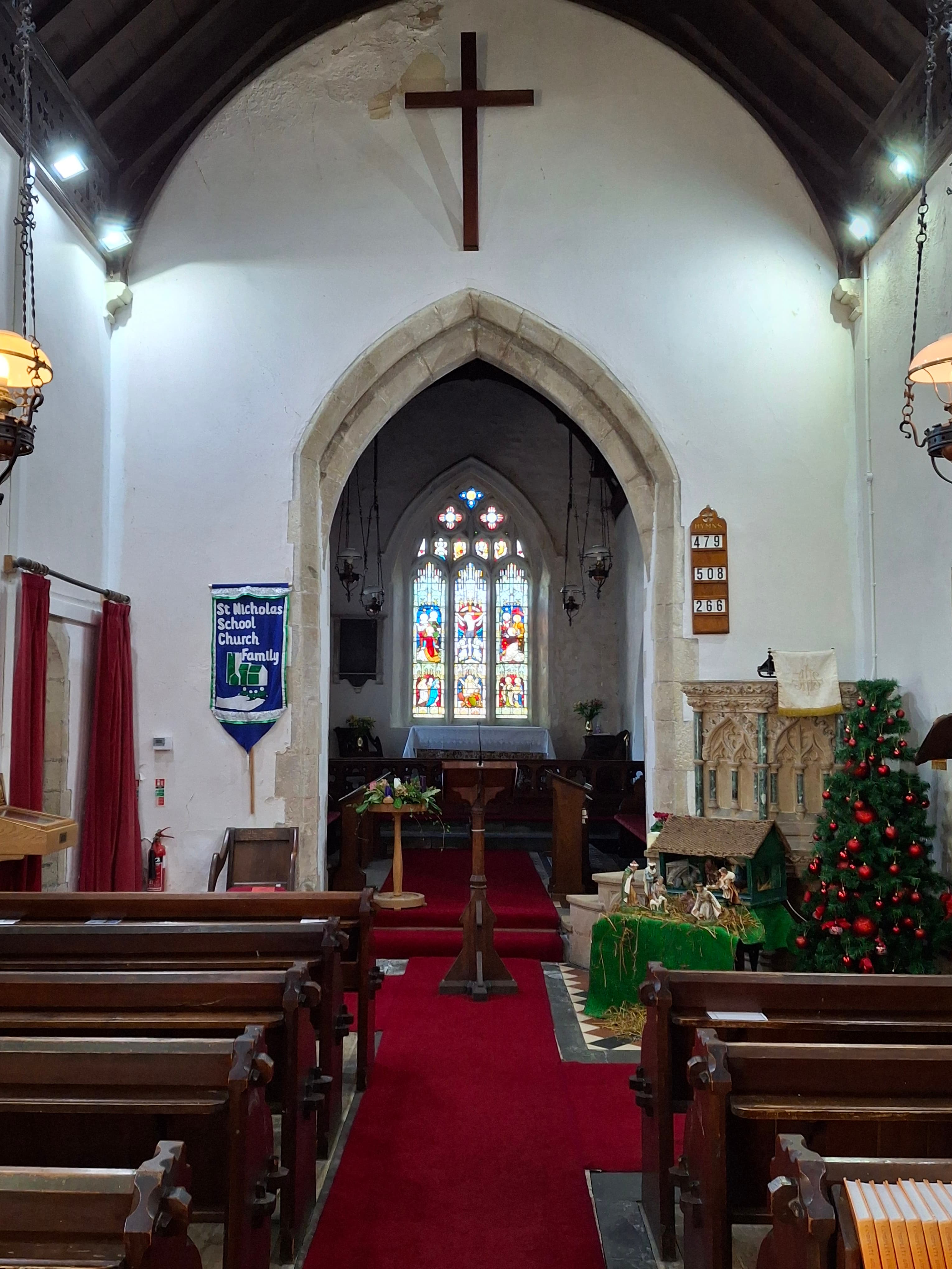The interior of St Nicholas Church showing the apse and stained glass