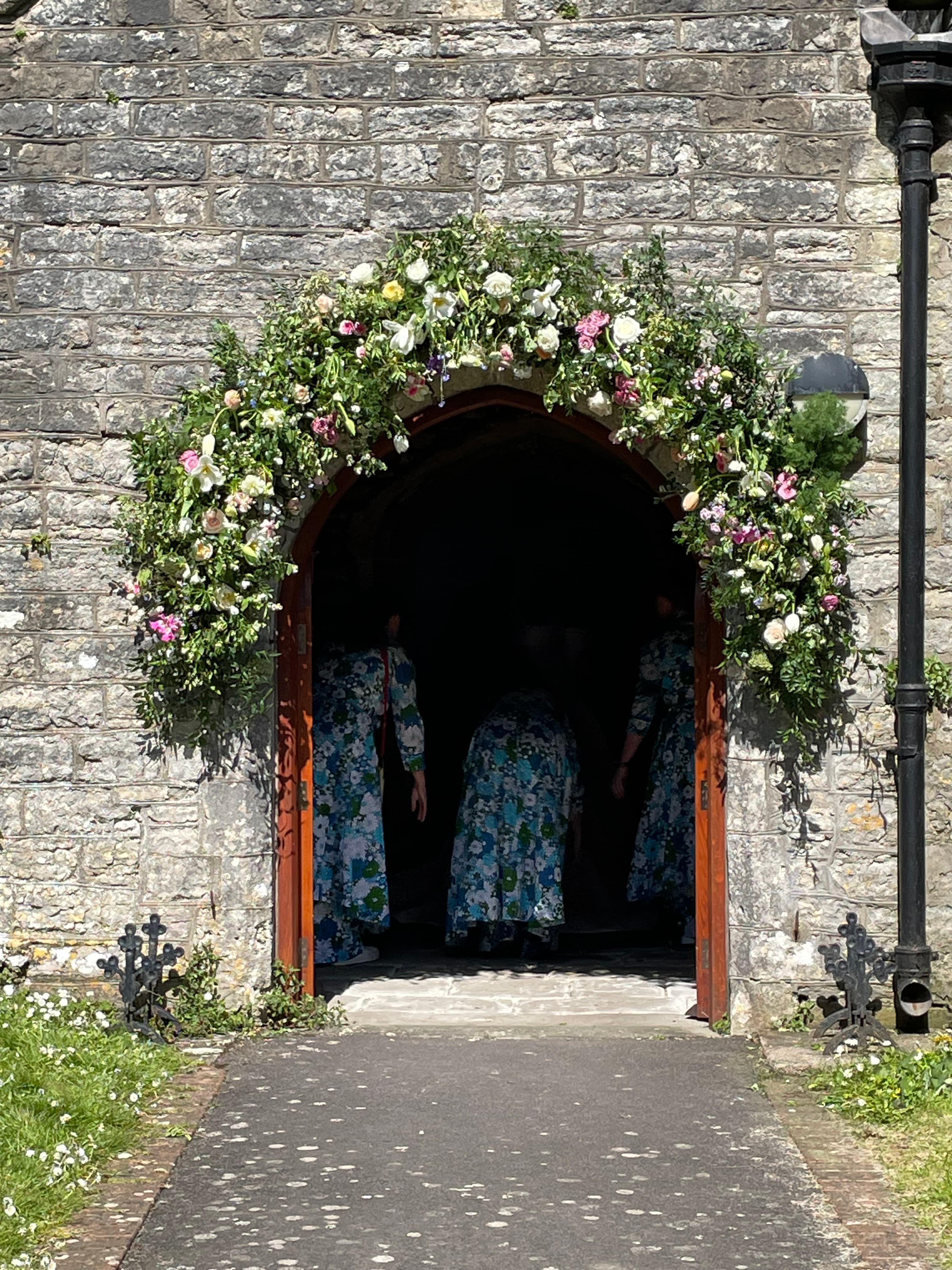 The flower-decorated entrance to St Nicholas Church for a wedding